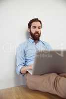 Handsome hipster using his laptop