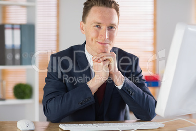 Happy businessman working at his desk