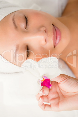 Attractive young woman holding a flower