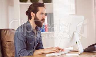 Hipster businessman working at his desk