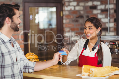 Customer handing a credit card to the waitress