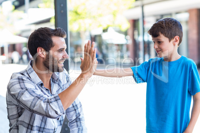 Son and father doing high five