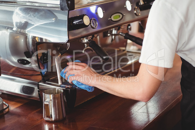 Barista cleaning coffee machine