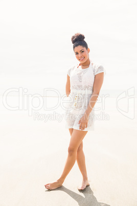 Stylish girl posing on the sand