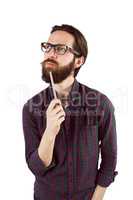 Handsome hipster thinking and holding pen