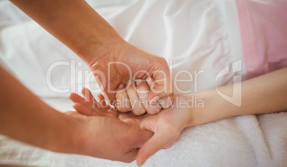 Young woman getting hand massage