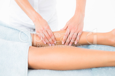 Female masseur massaging womans leg