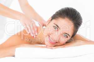 Attractive woman receiving back massage at spa center