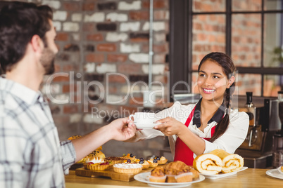 Smiling waitress serving a client