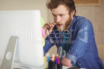 Focused hipster working at his desk