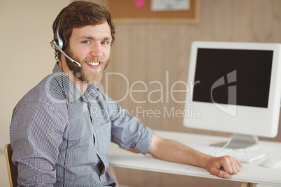 Bearded hipster working and smiling
