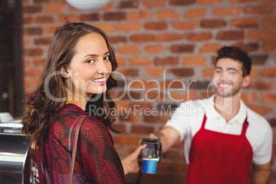 Smiling woman handing a pin terminal