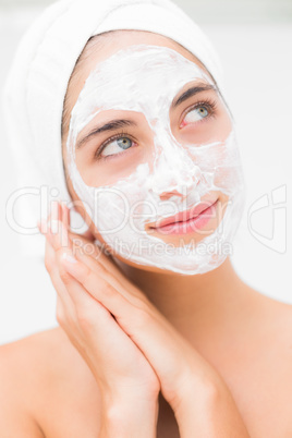 Attractive woman having white cream on her face