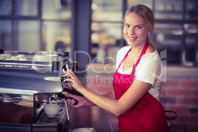 A pretty barista preparing coffee