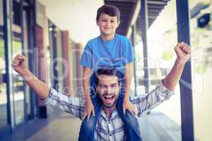 portrait of a father and son piggybacking