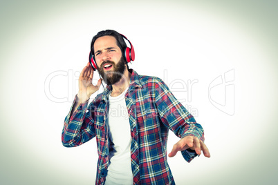 Handsome hipster enjoying listening to music