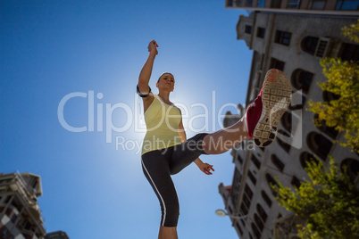 A beautiful woman jumping in the street