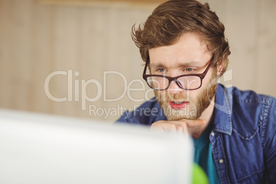 Focused hipster working at his desk