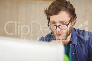 Focused hipster working at his desk