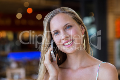 Smiling attractive woman phoning with smartphone