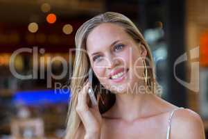 Smiling attractive woman phoning with smartphone