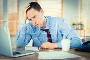 Stressed businessman working at his desk