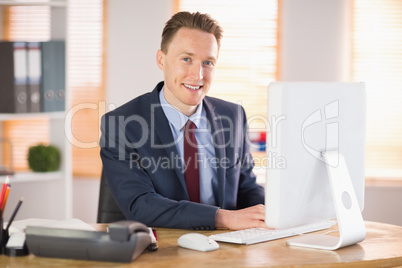 Stylish businessman working at his desk