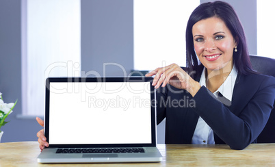 Confident businesswoman showing her laptop