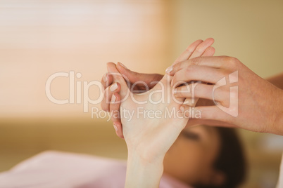 Young woman getting hand massage