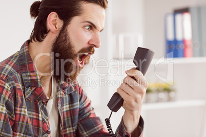 Hipster angry businessman making a call