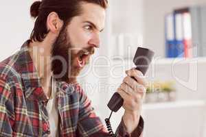 Hipster angry businessman making a call