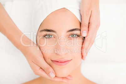 Attractive woman receiving facial massage at spa center Attractive woman receiving facial massage at spa center