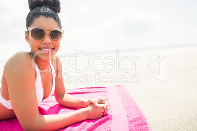 Smiling woman sunbathing on towel