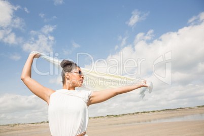 Stylish woman holding her scarf