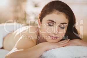 Young woman lying on massage table