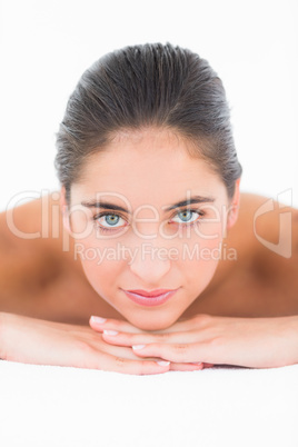 A portrait smiling pretty brunette on massage table