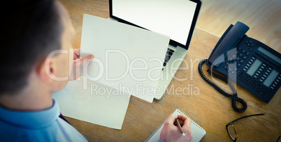 Focused businessman reading document at desk