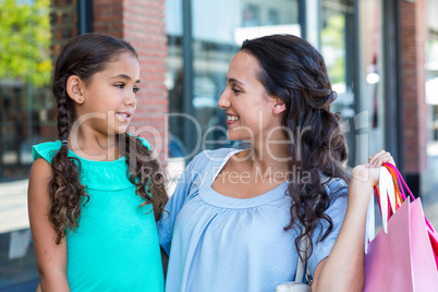 A mother and her daughter smiling at each other