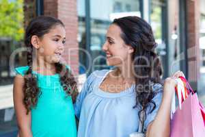 A mother and her daughter smiling at each other