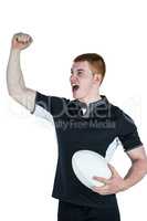 A rugby player gesturing victory