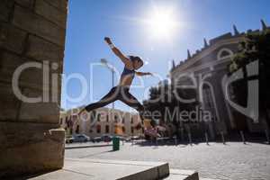 Athletic woman jumping off the stairs