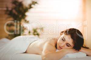 Young woman lying on massage table