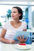 Happy woman enjoys using her tablet