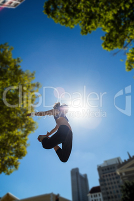 Athletic woman jumping in the air