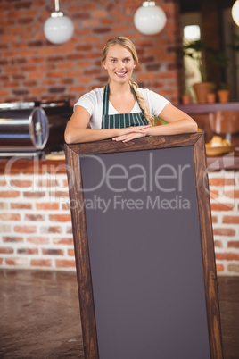 Pretty waitress holding a big chalkboard