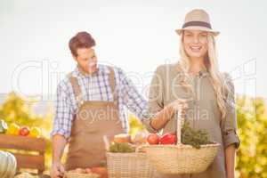 Blonde customer holding a vegetables basket