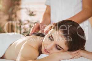 Young woman getting a hot stone massage