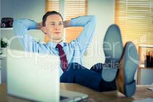 Relaxed businessman with his feet up