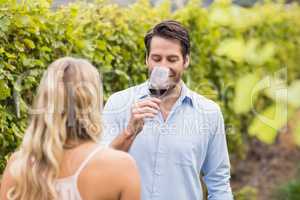 Young happy couple tasting wine