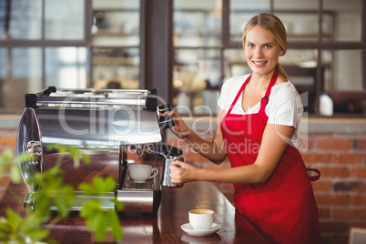 A pretty barista preparing coffee